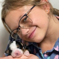 girl holding puppy